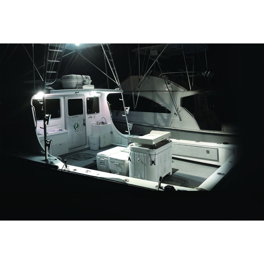 SR-M & SR-Q Pods by Rigid: A sport fishing boat cockpit is lit bright white by deck lights at night.
