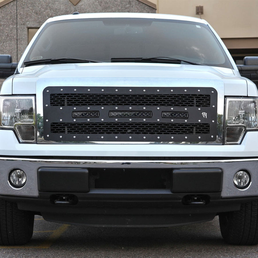 SR-Series Light Bars by Rigid: A white Ford F-150 wears a black mesh grille fitted with three small Rigid LED light bars.