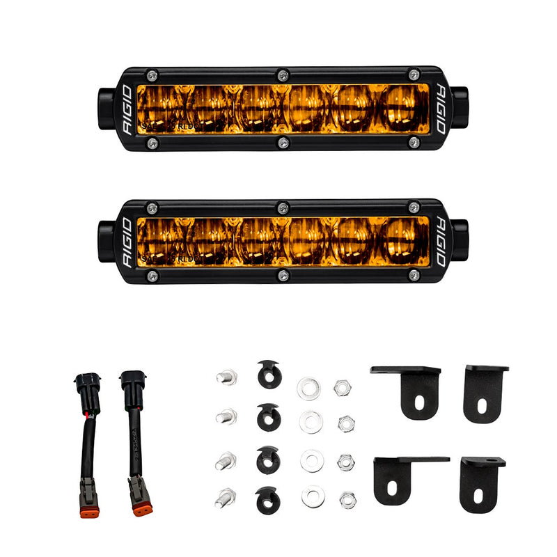 Rigid Selective Yellow SAE Fog Light Kit, kit contents laid out: kit layout of two selective yellow LED fog light bars with wiring adapters, mounting hardware and four brackets on white