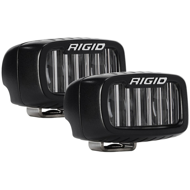 Rigid SR-M Series PRO SAE Fog Light Pod Pair on a studio background: A pair of black Rigid SR-M SAE fog pods with clear fluted lenses on a white background