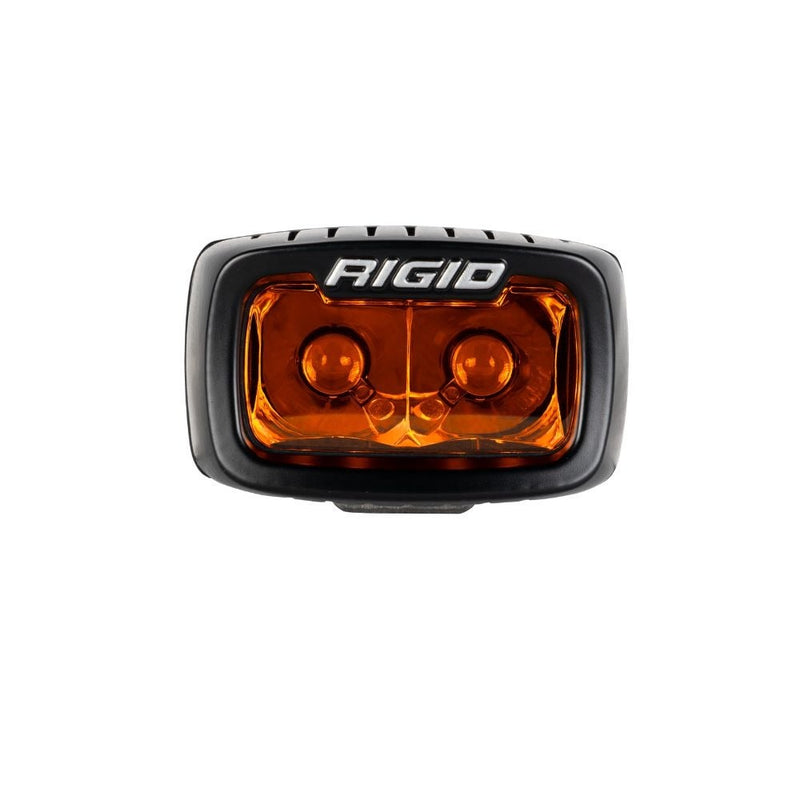 Rigid SR-M Series Spot Pod Amber PRO on a studio background: A black SR-M pod with an amber spot lens, front view on a white background
