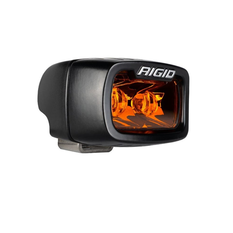 Rigid SR-M Series Spot Pod Amber PRO on a studio background: an angled view of a black SR-M pod with an amber lens on a white background
