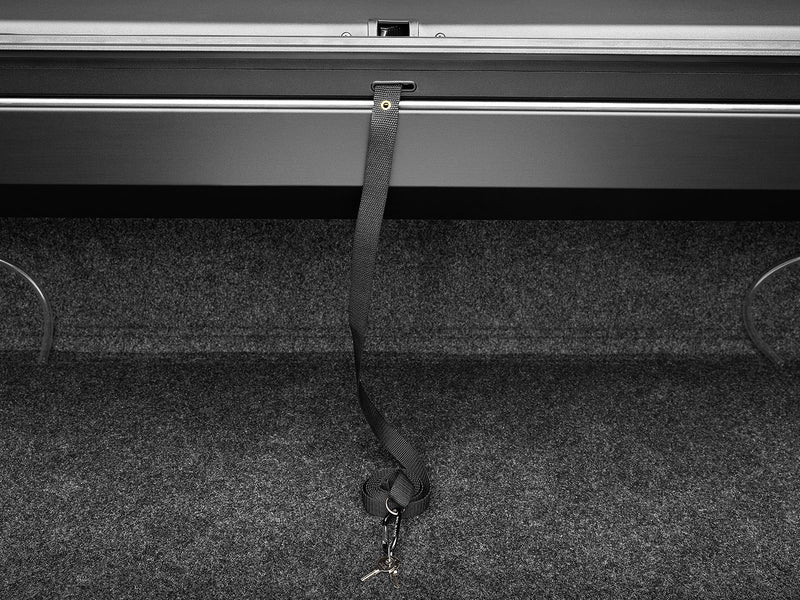 Roll-N-Lock A-Series side rail and pull strap over a lined bed floor