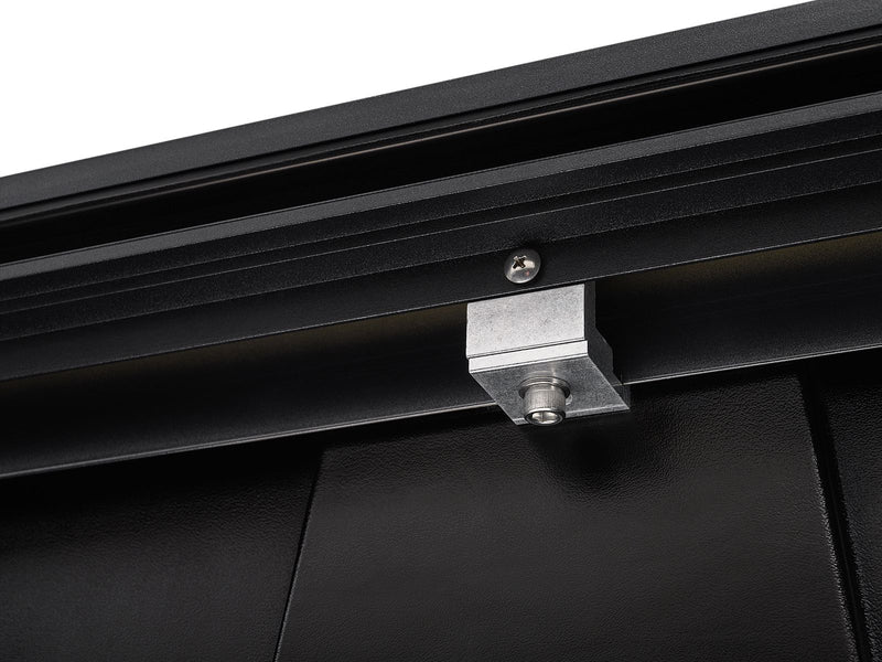 Roll-N-Lock A-Series XT cast rail bracket and bolt under the bed lip