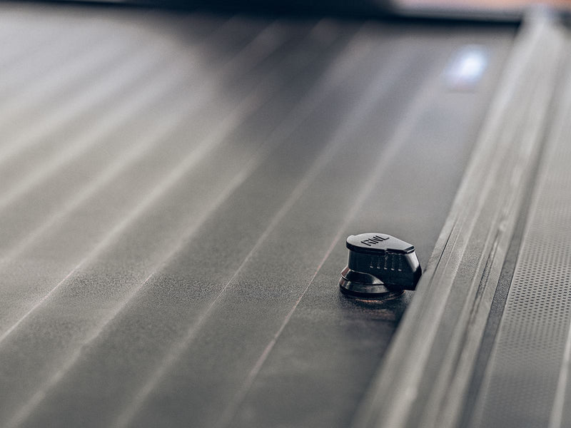 Roll-N-Lock A-Series XT aluminum slat surface with a T-slot tie-down knob fitted