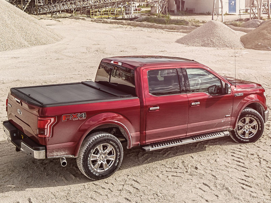 Roll-N-Lock A-Series cover closed, truck in side profile on a mountain road