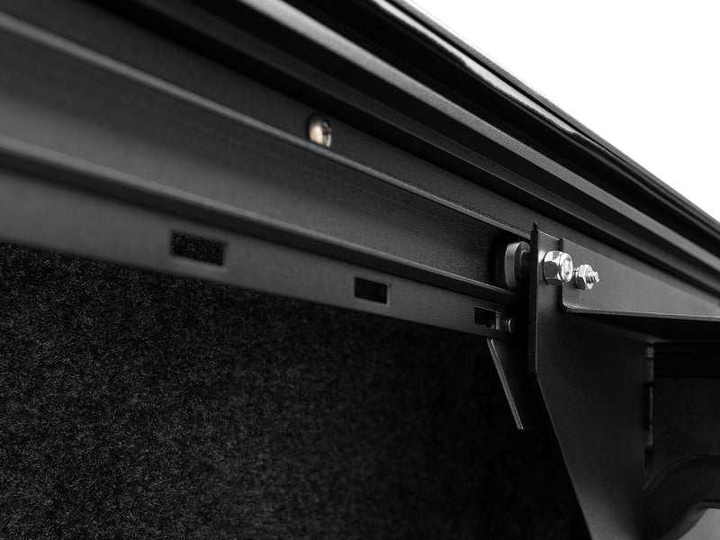 Roll-N-Lock Cargo Manager rail and its locking pin against a carpeted bed liner
