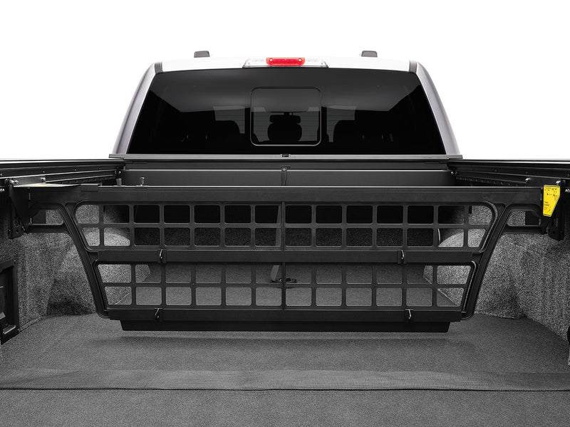 Roll-N-Lock Cargo Manager raised across the full width of a pickup bed, seen straight on from the tailgate