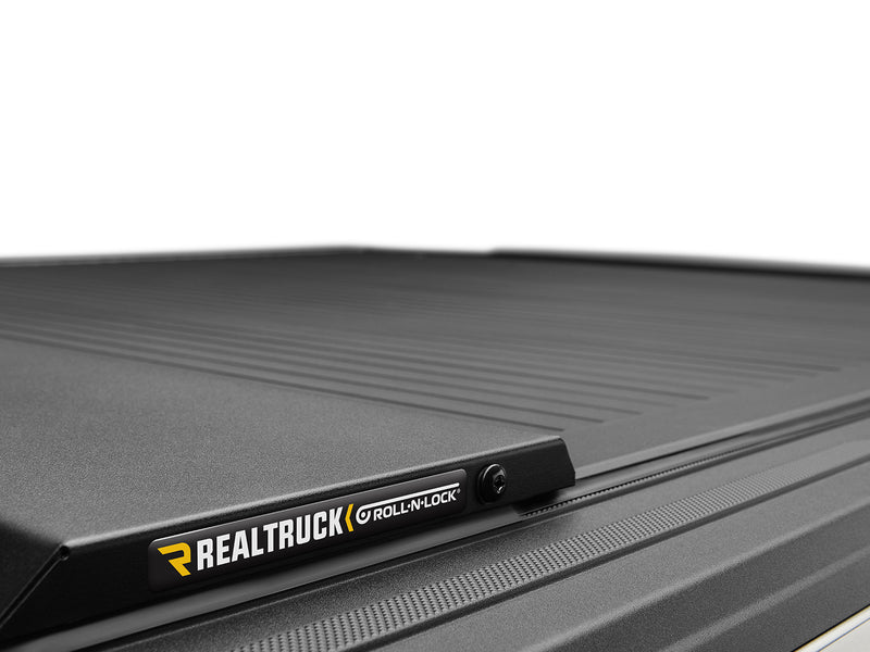 Roll-N-Lock E-Series name plate on the cover rail, photographed against a plain white background
