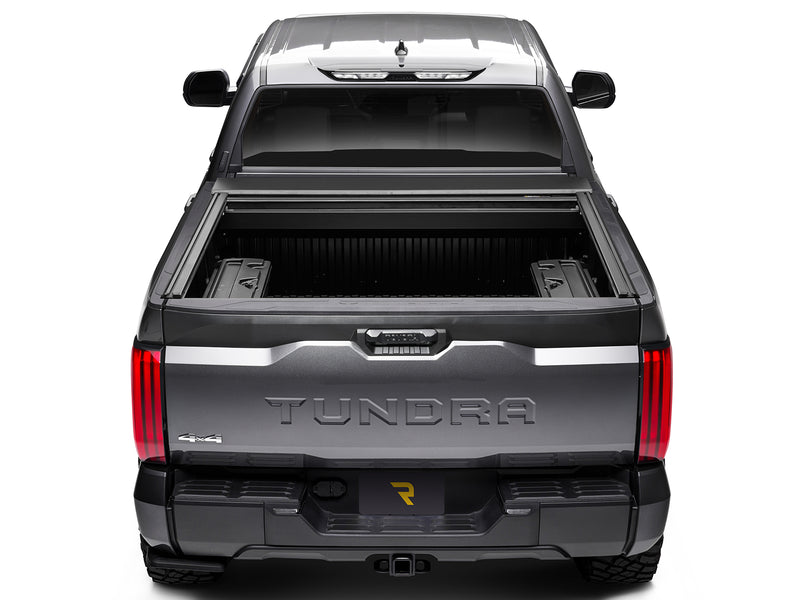 Roll-N-Lock E-Series XT fully retracted, straight rear view with both rails and the bed floor visible