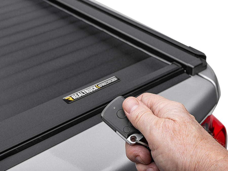 Key fob in hand over a closed Roll-N-Lock E-Series XT cover