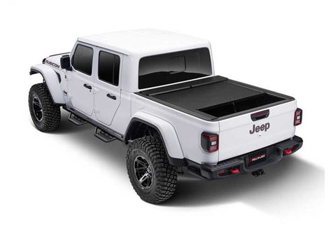 Roll-N-Lock M-Series fitted to a white 2020-2026 Jeep Gladiator Rubicon