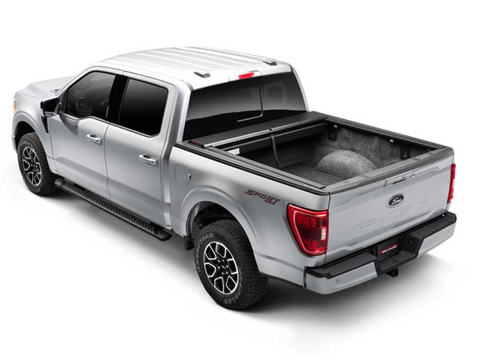 Roll-N-Lock M-Series fully retracted into its canister on a 2021 Ford F-150, open bed