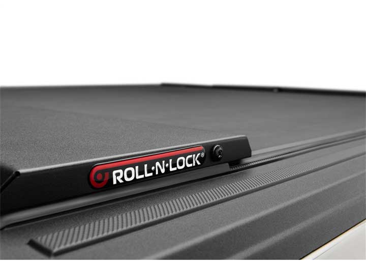 Roll-N-Lock M-Series rear latch rail and lock cylinder with the Roll-N-Lock badge