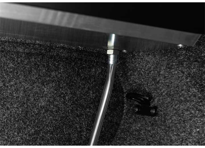 Roll-N-Lock M-Series drain tube routed down inside the bed corner