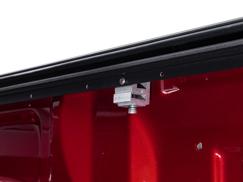 Roll-N-Lock M-Series track clamped to the inside of the bed rail