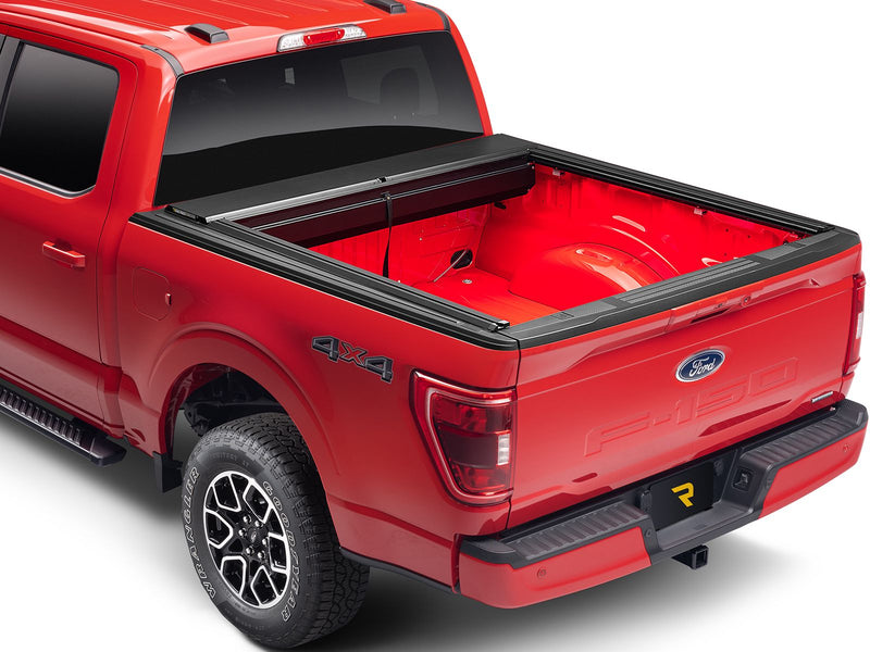 Roll-N-Lock M-Series XT fully retracted on a 2021-2026 Ford F-150, rear three-quarter view of the open bed