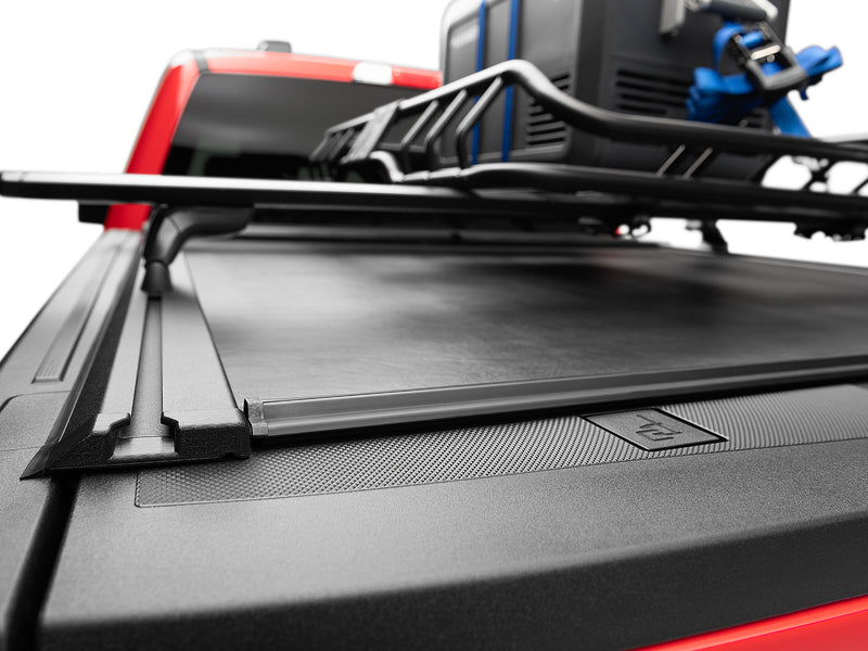 Loaded cargo basket carried on the Roll-N-Lock M-Series XT MaxTrak T-slot rails over the closed cover