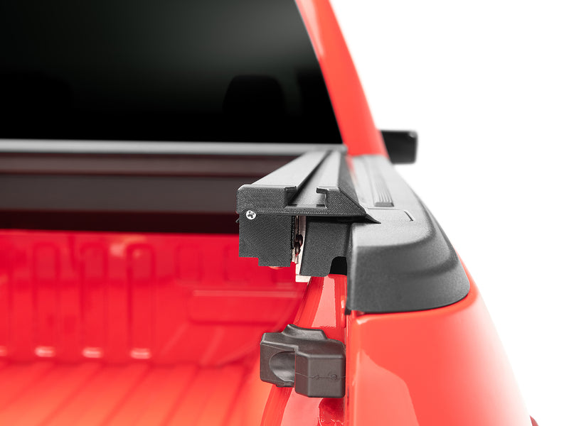 Roll-N-Lock M-Series XT rail end cap and latch hardware with the tailgate down