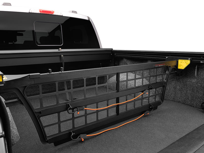 Roll-N-Lock Cargo Manager bed divider with a strap over the grid (strap and tonneau cover sold separately)