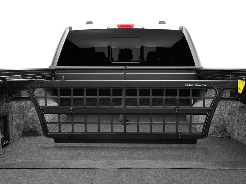 Roll-N-Lock Cargo Manager bed divider raised across the full bed width, straight-on view (tonneau cover sold separately)