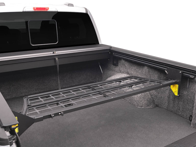Roll-N-Lock Cargo Manager bed divider rotated up level with the rails over an empty bed (tonneau cover sold separately)