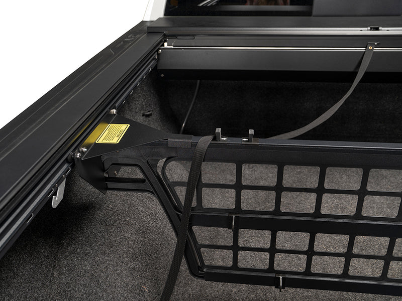 Roll-N-Lock Cargo Manager divider grid with a strap threaded through it (strap sold separately)