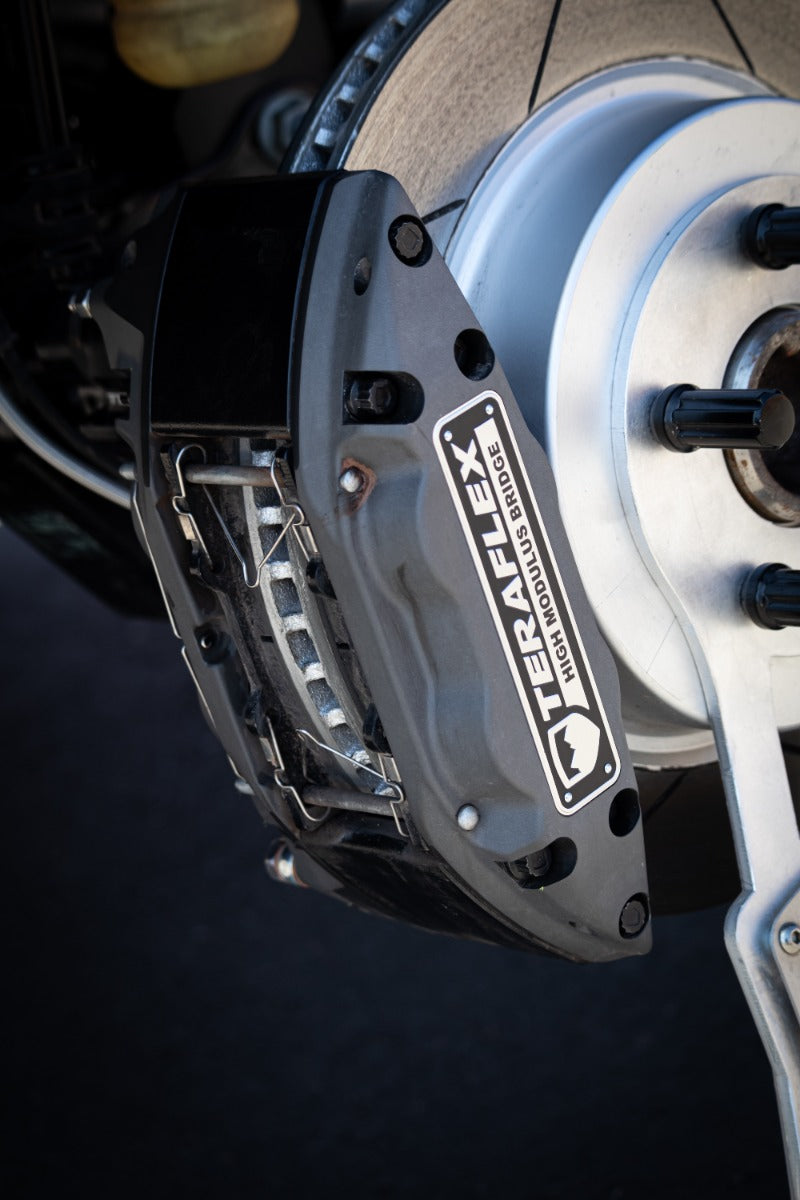 Close-up of the TeraFlex Brake Component: close-up of an installed gray TeraFlex High Modulus Bridge caliper over a slotted rotor
