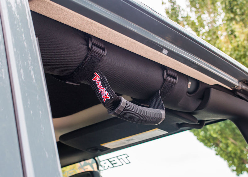 TeraFlex grab handle strapped to a Jeep roll bar near the windshield