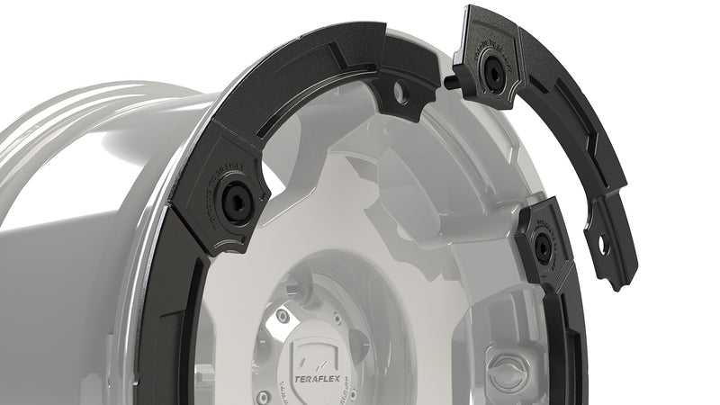 Close-up of TeraFlex modular rash ring segments separating from the wheel lip