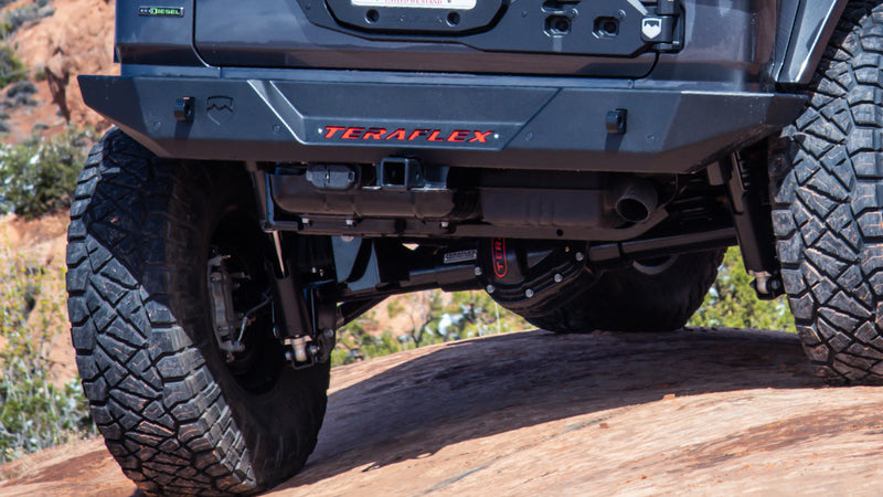 TeraFlex Rear Bumper on a Jeep Wrangler: rear view of gray Jeep Wrangler JL EcoDiesel with TeraFlex rear bumper and diff cover on red rock