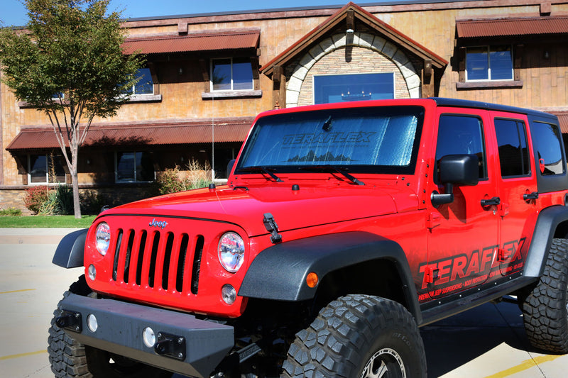 TeraFlex windshield sunshade installed in a red Jeep Wrangler JK Unlimited