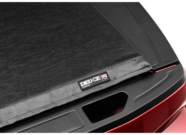 Close-up of the DEUCE name plate at the rear corner of the cover, above the tailgate handle recess on a TruXedo Deuce soft folding tonneau cover