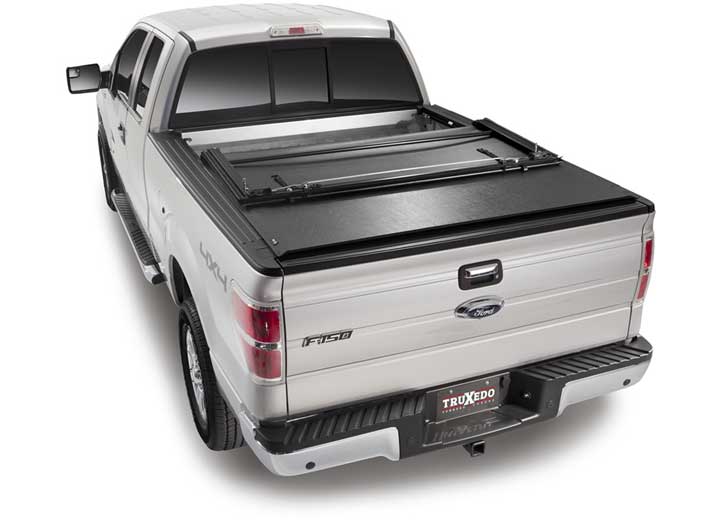 TruXedo Deuce soft folding tonneau cover folded flat at the bulkhead over the bed of a pickup truck, straight rear view