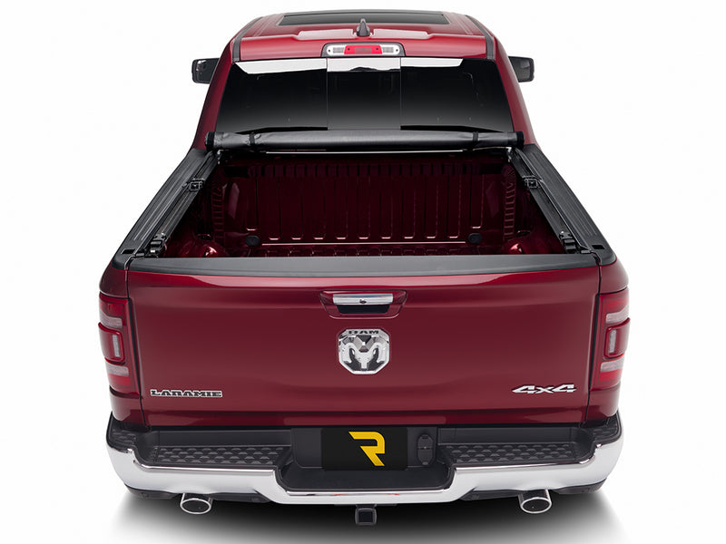 TruXedo Deuce soft folding tonneau cover folded flat at the bulkhead over the bed of a pickup truck, close straight rear view