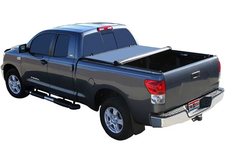 TruXedo Deuce soft folding tonneau cover folded partway open over the bed of a pickup truck, distant rear three-quarter view