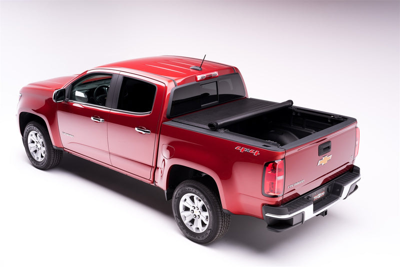 TruXedo Deuce soft folding tonneau cover folded partway open over the bed of a pickup truck, rear three-quarter view