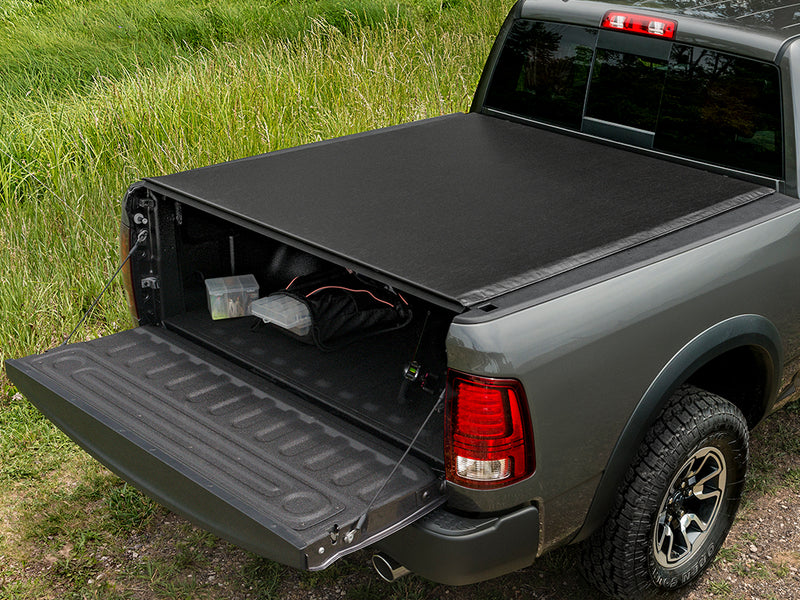 TruXedo Deuce soft folding tonneau cover folded partway open over the bed of a pickup truck, photographed on location