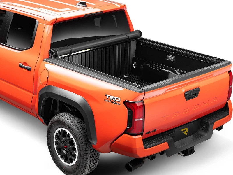 Lo Pro cover rolled all the way to the cab and strapped, leaving the full bed open, rear three-quarter view