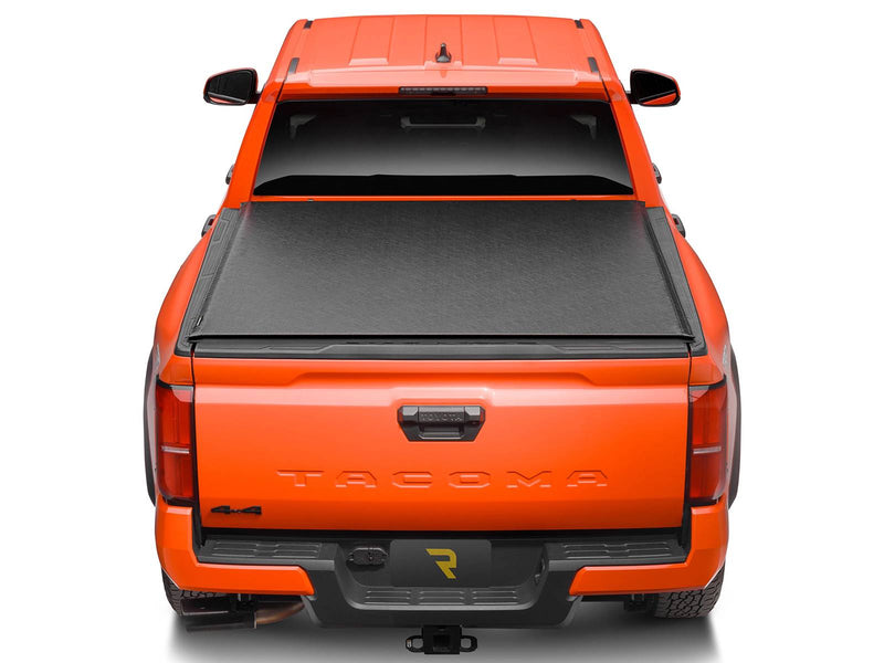 Lo Pro tonneau cover closed over the bed, seen from above and behind an orange pickup
