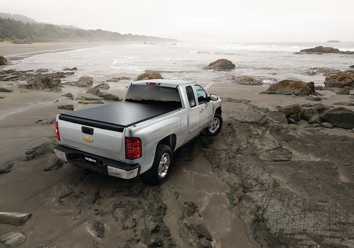 TruXedo Lo Pro soft roll-up tonneau cover closed on a pickup bed on a rocky coastal beach