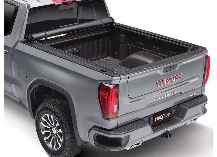 TruXedo Lo Pro soft roll-up tonneau cover rolled forward to the cab on a 2019-2024 GMC Sierra 1500, rear three-quarter view