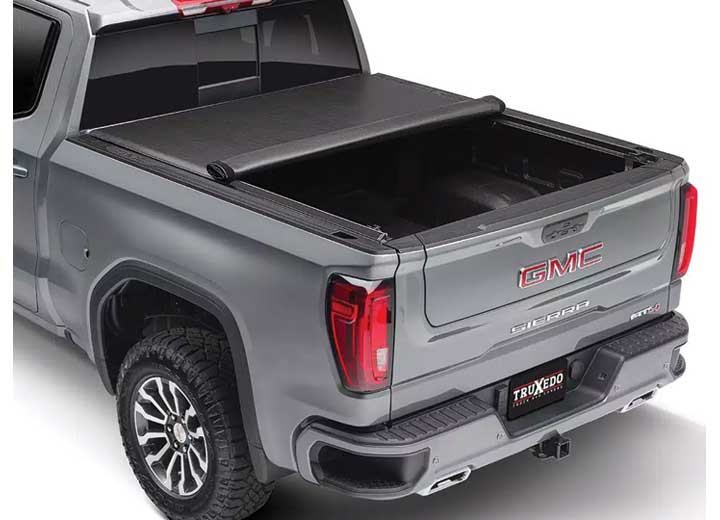 TruXedo Lo Pro soft roll-up tonneau cover rolled partway open on a 2019-2024 GMC Sierra 1500, rear three-quarter view