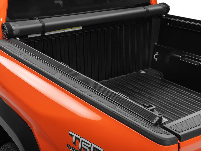 TruXedo Lo Pro soft roll-up tonneau cover fully open over the bed of a pickup truck, photographed on location