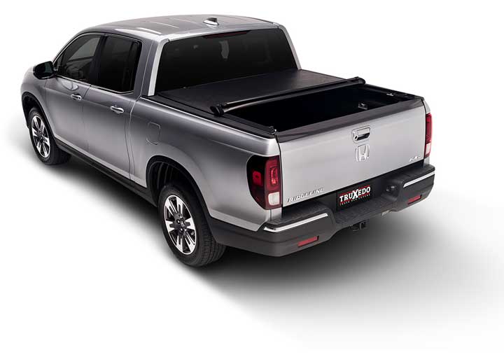 TruXedo Lo Pro soft roll-up tonneau cover rolled partway open over the bed of a pickup truck, straight rear view