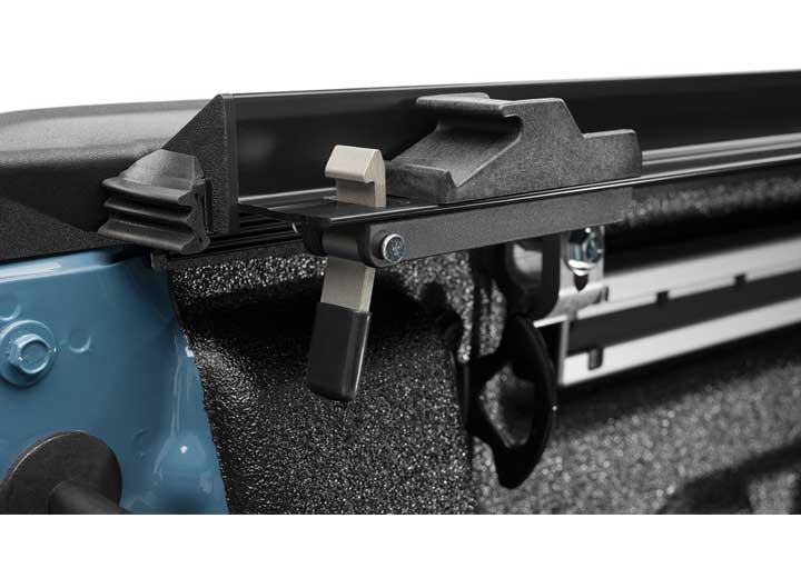 Close-up of the trigger latch at the rear corner on a TruXedo Lo Pro soft roll-up tonneau cover