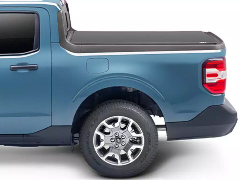 Side profile of the soft roll-up cover closed, sitting low along the bed rails