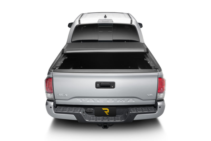 TruXedo Pro X15 soft roll-up tonneau cover rolled partway open on a 2016-2023 Toyota Tacoma, straight rear view