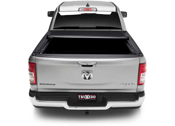 TruXedo Pro X15 soft roll-up tonneau cover rolled partway open on a 2019-2024 Ram 1500, straight rear view