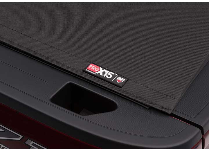 Close-up of the PRO X15 name plate above the raised lettering stamped into the tailgate on a TruXedo Pro X15 soft roll-up tonneau cover
